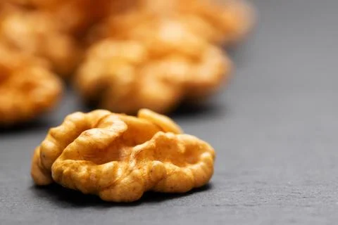 Walnuts. Walnut kernels on dark stone table. Vegetarian or healthy food Stock Photos