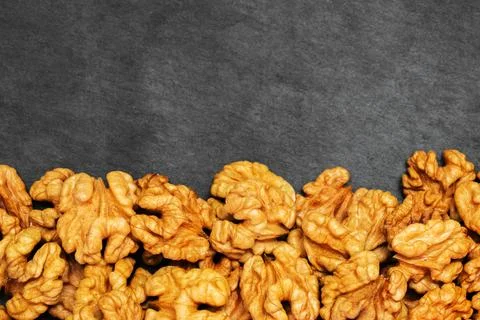 Walnuts. Walnut kernels on dark stone table. Top view Stock Photos