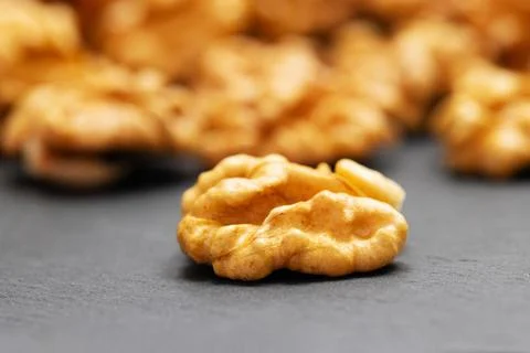 Walnuts. Walnut kernels on dark stone table. Vegetarian or healthy food Stock Photos