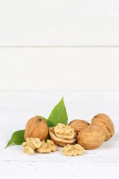 Walnuts walnut nuts portrait format copyspace on wooden board Stock Photos