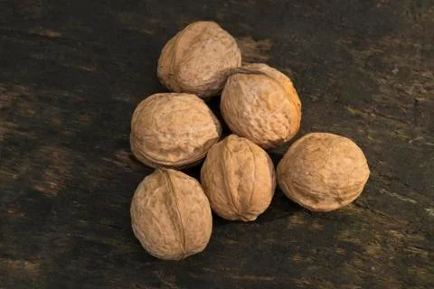 Walnuts, walnuts close-up, walnuts on a dark background, walnuts on a woode.. Stock Photos