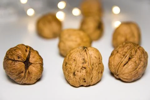 Walnuts on a white background with blurred lights Stock Photos