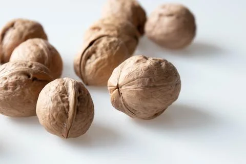 Walnuts on a white background. Close-up, selective focus. Stock Photos