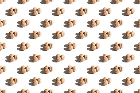 Walnuts on a white background. A pattern of walnuts on a white background. Hard Stock Photos