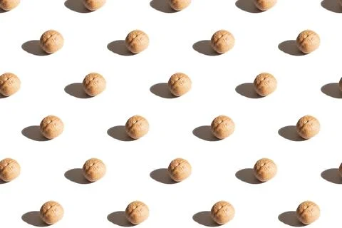 Walnuts on a white background. A pattern of walnuts on a white background. Stock Photos