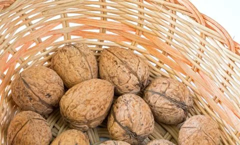 Walnuts &amp; wicker basket Stockfoto's