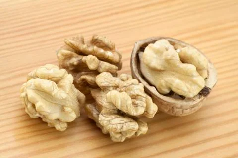 Walnuts on wooden surface Stock Photos