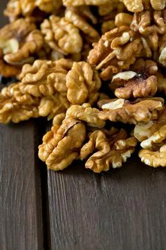 Walnuts on wooden surface Stock Photos