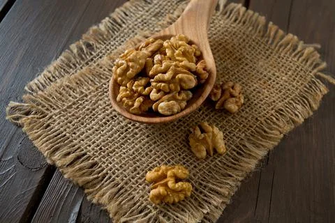 Walnuts on wooden surface Stock Photos