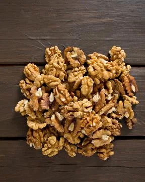 Walnuts on wooden surface Stock Photos