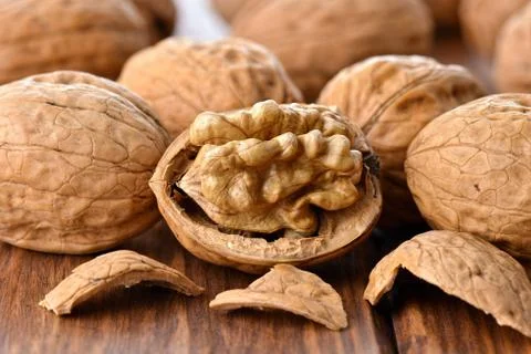 Walnuts on a wooden table Stock Photos
