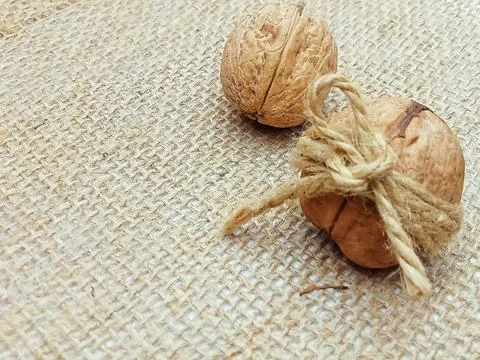 Walnuts Wrapped in Twine on Burlap Background Stock Photos