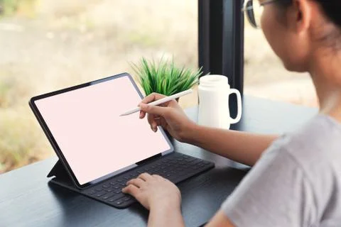 Waman using digital tablet with stylus pen and smart keyboard Stock Photos
