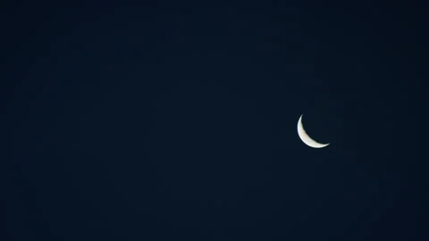Waning Crescent moon phase in the night time sky Stock Footage 153239223
