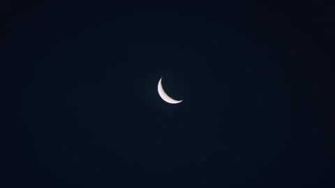 Waning Crescent moon phase in the night time sky Video stock 153239446