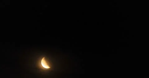 Waning crescent red moon rises and hides in night clouds, time lapse Stock Footage 317756617