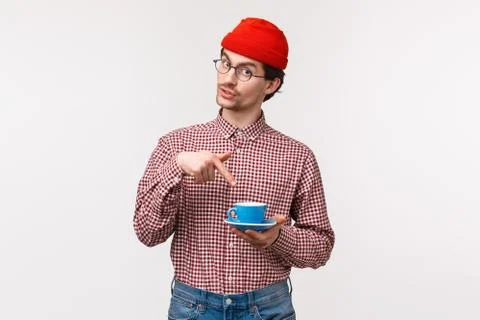 Want some. Friendly-looking funny young hipster bearded guy in red beanie and Stock Photos