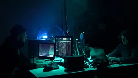 Wanted hackers coding virus ransomware using laptops and computers in the Stock Footage 99579948