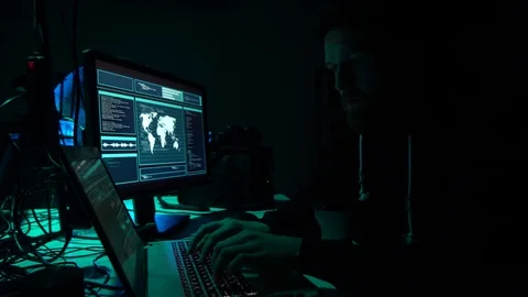 Wanted hackers coding virus ransomware using laptops and computers in the Stock Footage 101777514