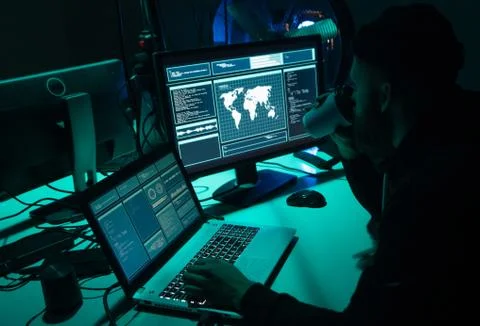 Wanted hackers coding virus ransomware using laptops and computers. Cyber attack 写真素材