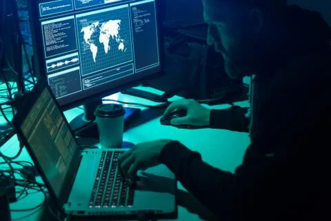 Wanted hackers coding virus ransomware using laptops and computers. Cyber attack Stock Photos