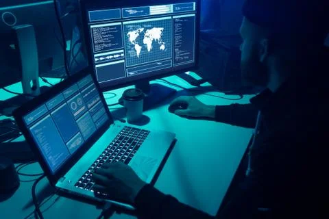 Wanted hackers coding virus ransomware using laptops and computers. Cyber attack 库存照片