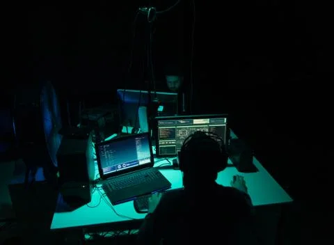 Wanted hackers coding virus ransomware using laptops and computers. Cyber attack Stock Photos