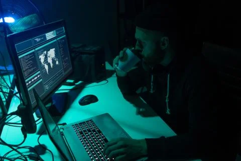 Wanted hackers coding virus ransomware using laptops and computers. Cyber attack Foto stock