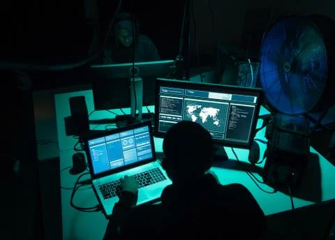 Wanted hackers coding virus ransomware using laptops and computers. Cyber attack 写真素材