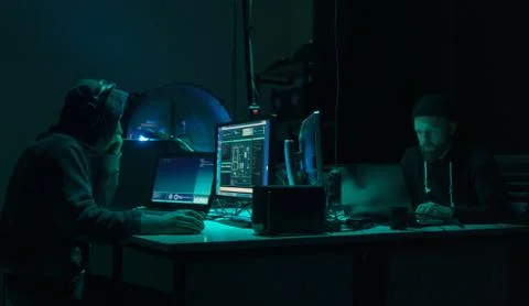 Wanted hackers coding virus ransomware using laptops and computers. Cyber attack 写真素材