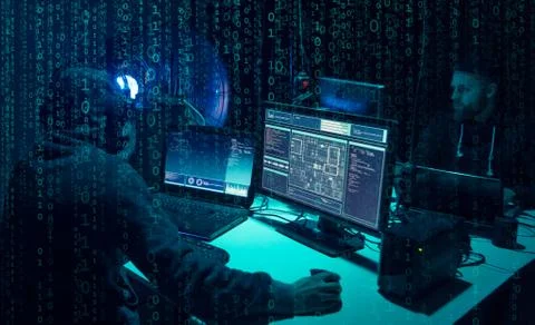 Wanted hackers coding virus ransomware using laptops and computers. Cyber attack Stock Photos