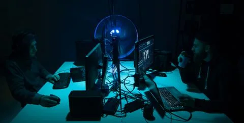 Wanted hackers coding virus ransomware using laptops and computers. Cyber attack Stock Photos