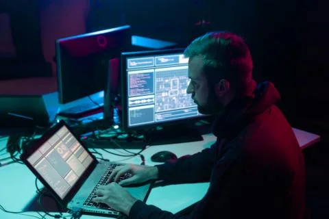 Wanted hackers coding virus ransomware using laptops and computers in the 写真素材