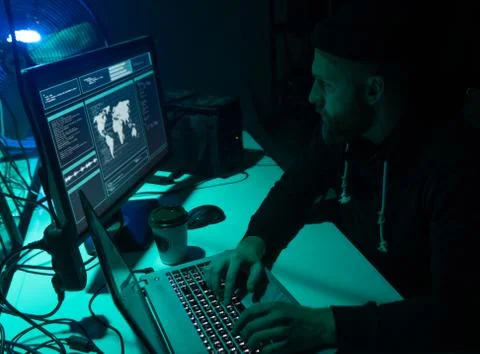 Wanted hackers coding virus ransomware using laptops and computers. Cyber attack Foto stock
