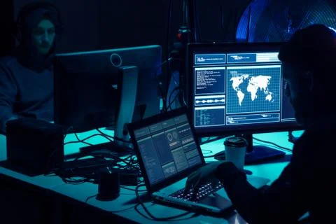 Wanted hackers coding virus ransomware using laptops and computers. Cyber attack 库存照片
