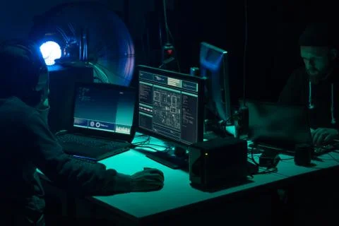 Wanted hackers coding virus ransomware using laptops and computers. Cyber attack 库存照片