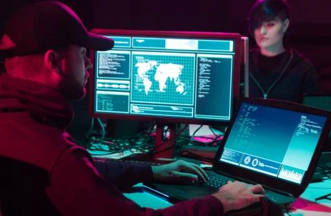 Wanted hackers coding virus ransomware using laptops and computers in the 写真素材