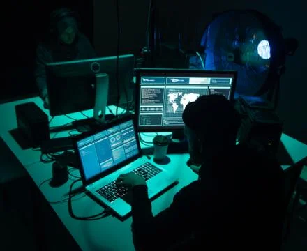 Wanted hackers coding virus ransomware using laptops and computers. Cyber attack 库存照片
