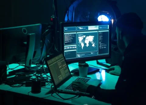 Wanted hackers coding virus ransomware using laptops and computers. Cyber attack Foto stock
