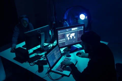 Wanted hackers coding virus ransomware using laptops and computers. Cyber attack Foto stock