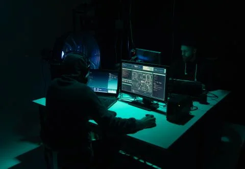 Wanted hackers coding virus ransomware using laptops and computers. Cyber attack 库存照片