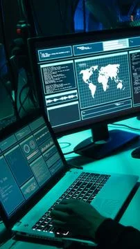 Wanted hackers coding virus ransomware using laptops and computers. Cyber attack Stock Photos