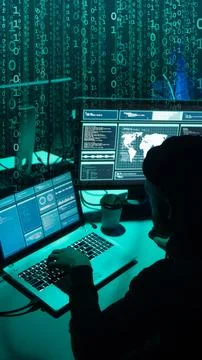 Wanted hackers coding virus ransomware using laptops and computers. Cyber attack Foto stock