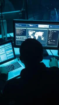 Wanted hackers coding virus ransomware using laptops and computers. Cyber attack Foto stock
