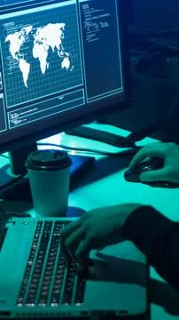 Wanted hackers coding virus ransomware using laptops and computers. Cyber attack Stock Photos