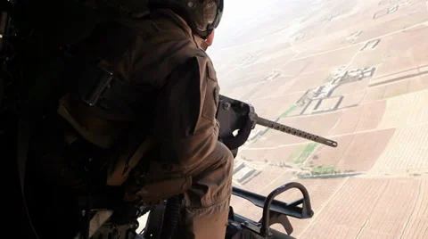 War in Afghanistan - Attack Helicopter Gunner Looking for Targets Stock Footage