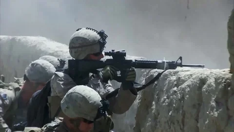 War in Afghanistan - U.S.  Marines shooting over wall in heavy battle with enemy Stock Footage