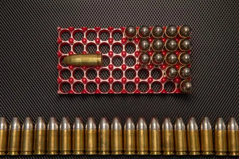 War concept. Bullets and shells in the hands of a child, against the background Stock Photos