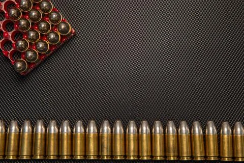 War concept. Bullets and shells in the hands of a child, against the background Stock Photos