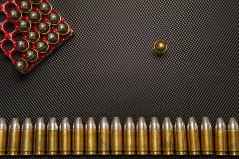 War concept. Bullets and shells in the hands of a child, against the background Stock Photos